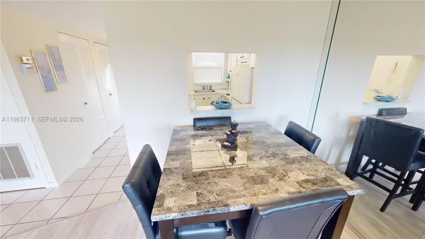 a dining room with furniture and wooden floor