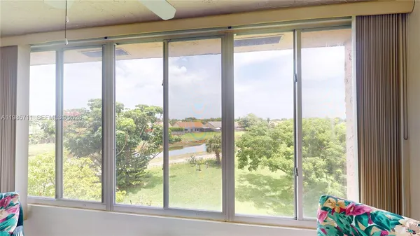 a view of an empty room and floor to ceiling window