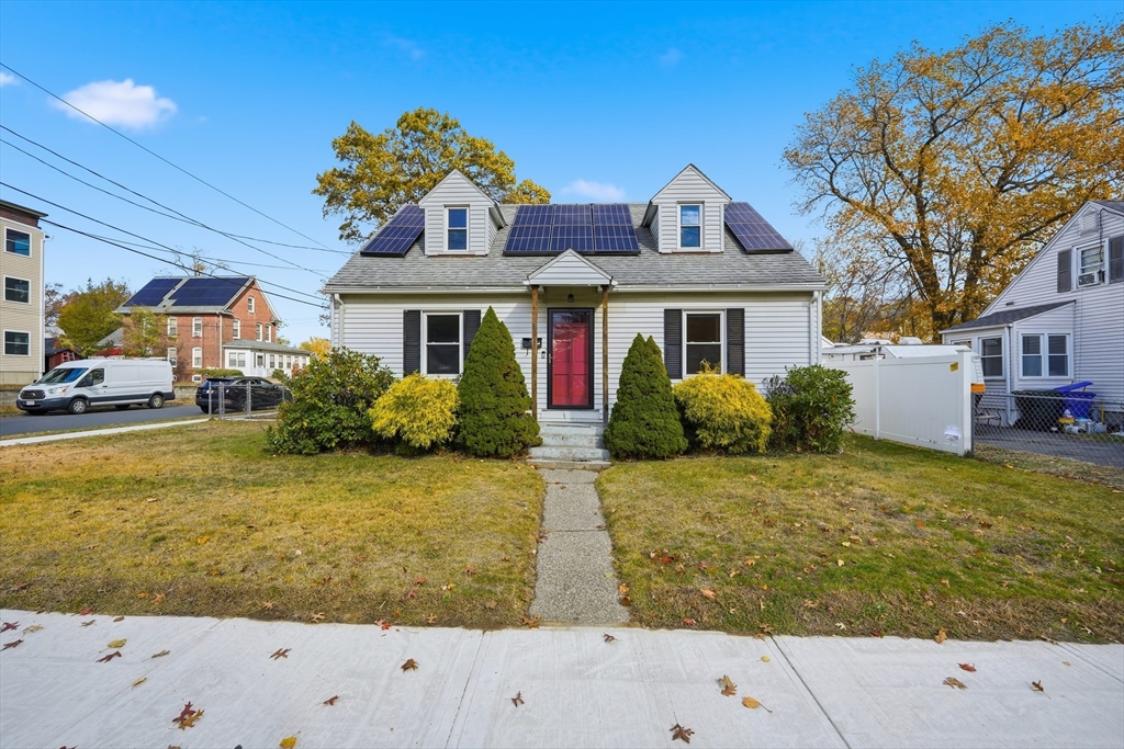 a front view of house with yard and trees