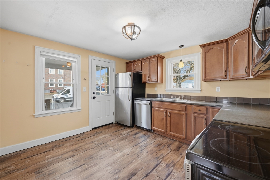 803 Armory Street Springfield, MA 01107 - Photo 11 of 34 a kitchen with granite countertop a stove top oven sink and cabinets