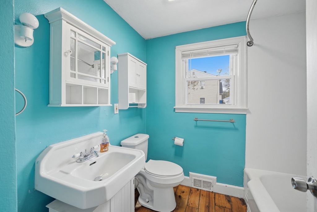 803 Armory Street Springfield, MA 01107 - Photo 14 of 34 a bathroom with a sink mirror and toilet