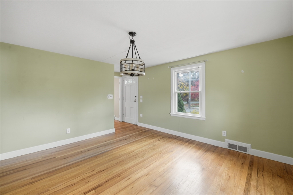803 Armory Street Springfield, MA 01107 - Photo 17 of 34 a view of empty room with wooden floor fan and window