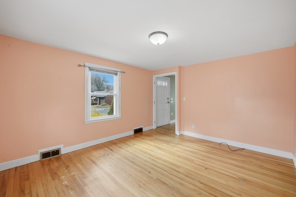 803 Armory Street Springfield, MA 01107 - Photo 19 of 34 an empty room with wooden floor and windows