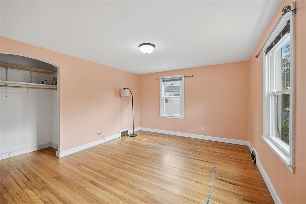 803 Armory Street Springfield, MA 01107 - Photo 21 of 34 a view of an empty room with wooden floor and a window
