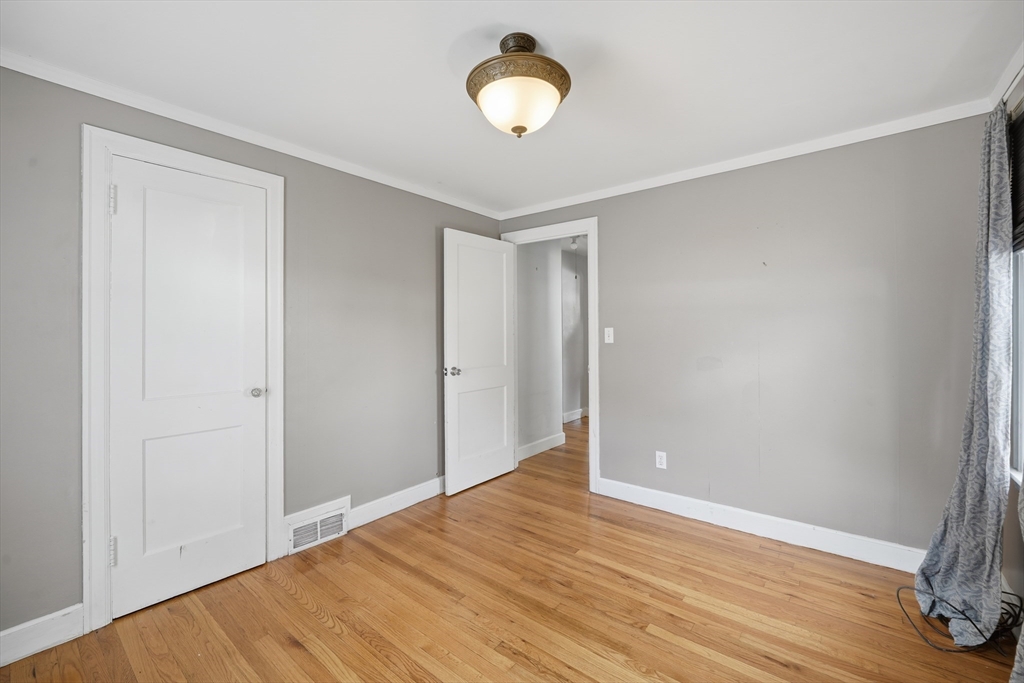 803 Armory Street Springfield, MA 01107 - Photo 23 of 34 a view of an empty room with wooden floor
