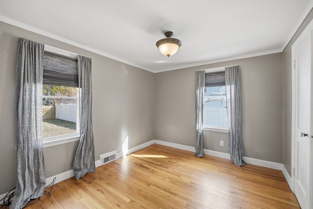 803 Armory Street Springfield, MA 01107 - Photo 24 of 34 wooden floor in an empty room with a window