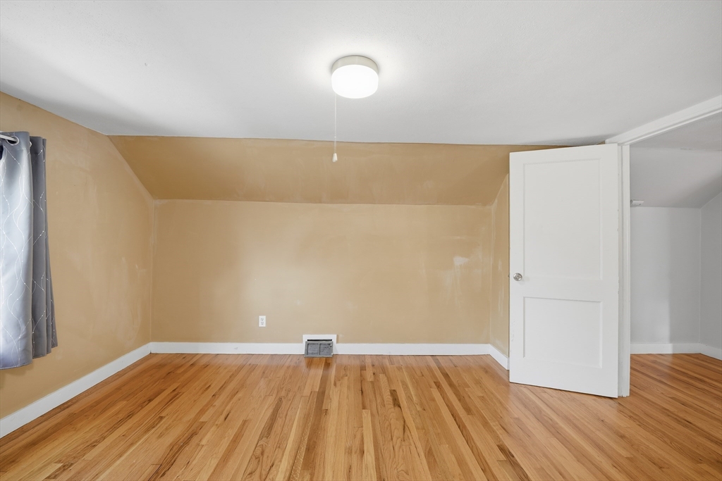 803 Armory Street Springfield, MA 01107 - Photo 29 of 34 a view of room with wooden floor