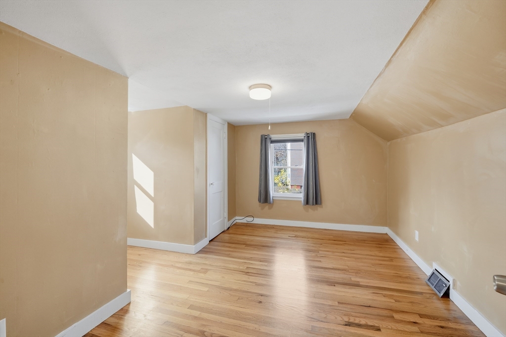 803 Armory Street Springfield, MA 01107 - Photo 31 of 34 a view of an empty room with window and wooden floor