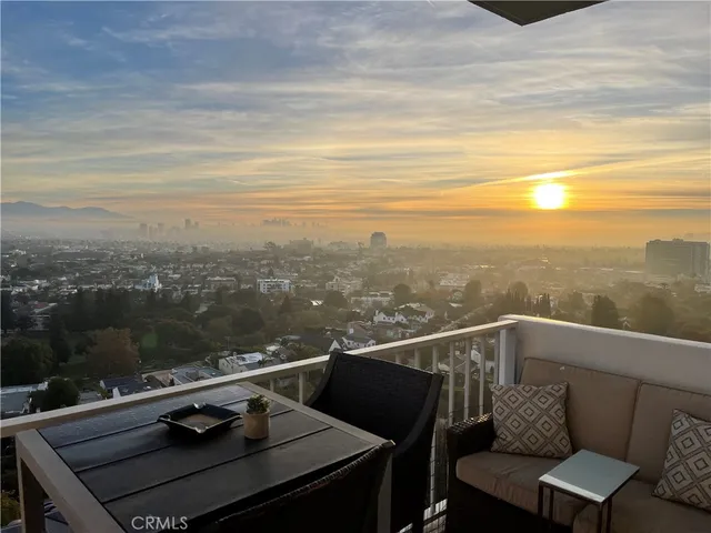 a view of a balcony with an outdoor seating