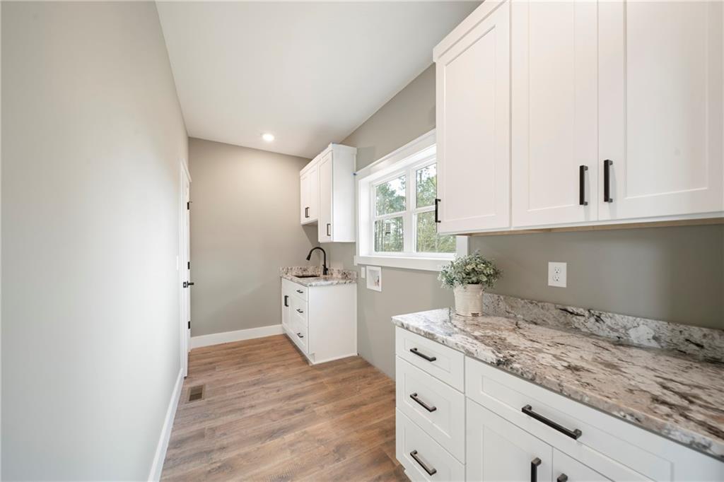 2956 Blalock Mountain Road Talking Rock, GA 30175 - Photo 23 of 65 a kitchen with granite countertop white cabinets and white appliances
