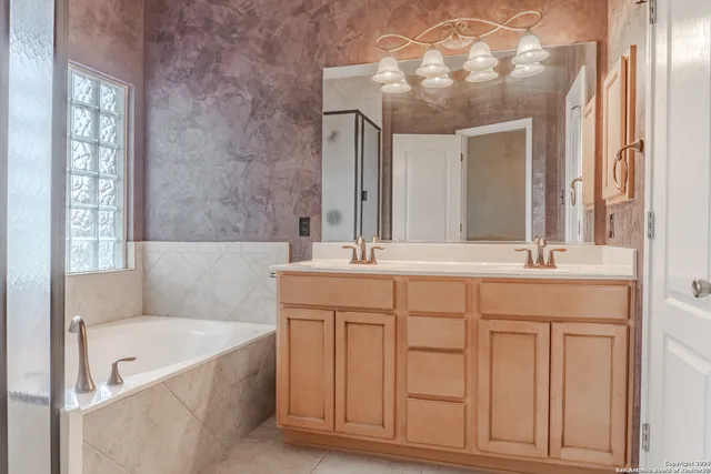 a white bath tub sitting in a bathroom next to a window