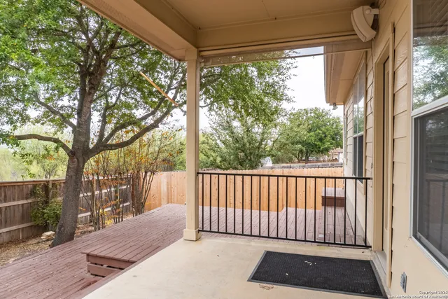 a porch with a bench next to a yard