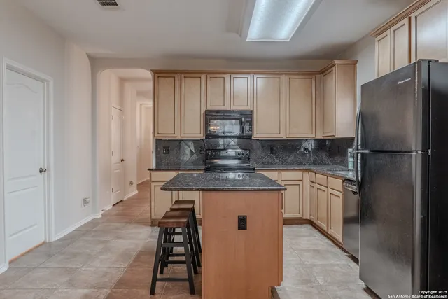 a refrigerator sitting inside of a kitchen