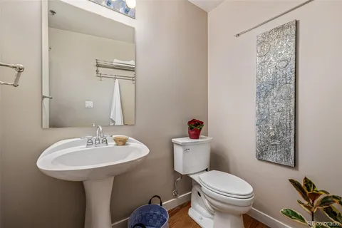 a bathroom with a sink toilet and a mirror
