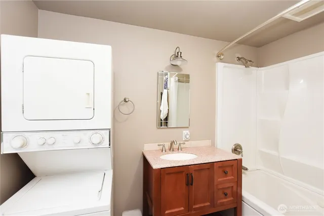 a bathroom with a sink mirror vanity and toilet