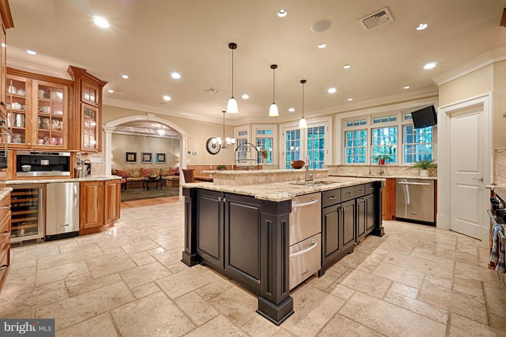 1301 Sawbridge Way Reston, VA 20194 - Photo 11 of 30 a kitchen with stainless steel appliances granite countertop a stove and a sink