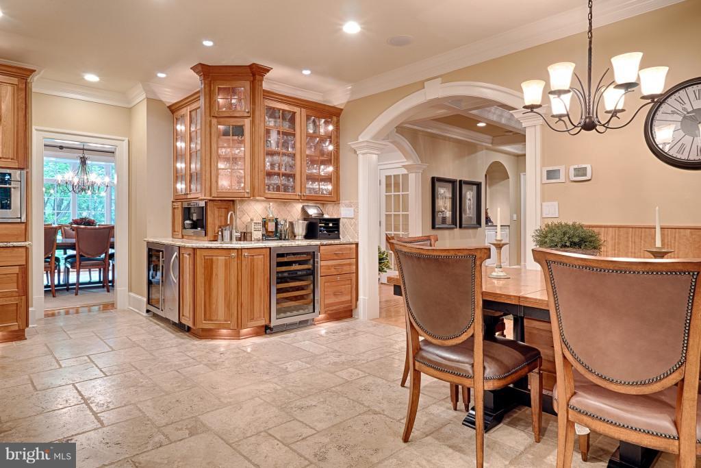 1301 Sawbridge Way Reston, VA 20194 - Photo 13 of 30 a view of a dining room with furniture a chandelier and kitchen view