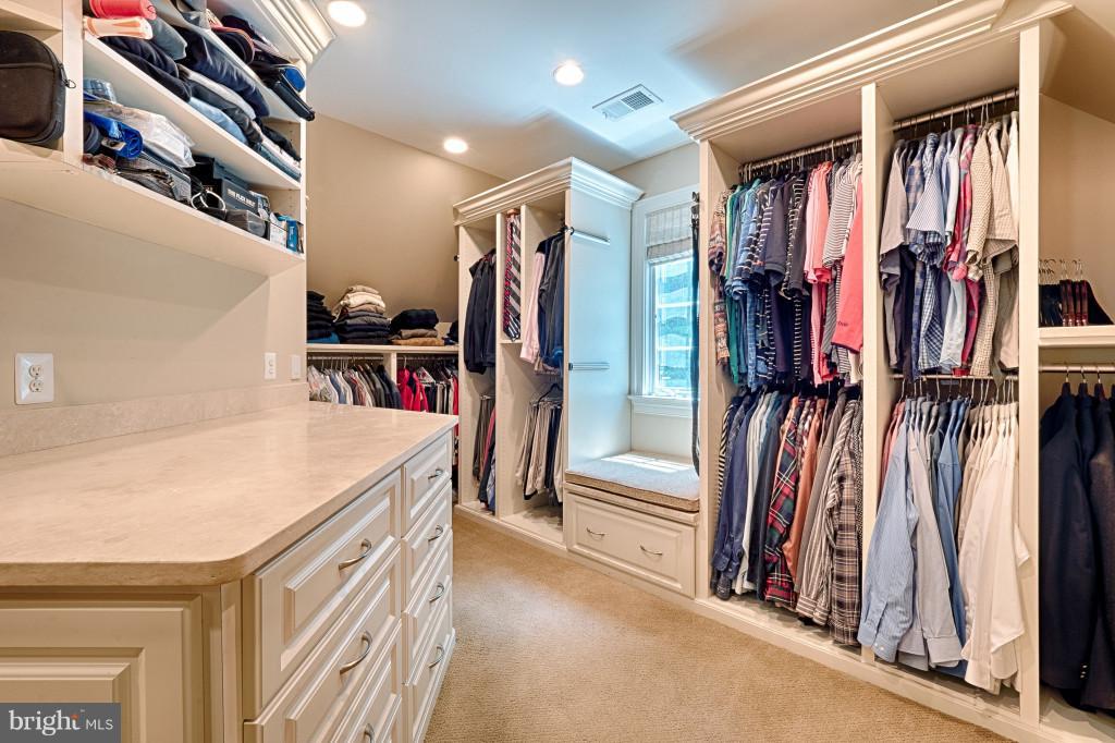 1301 Sawbridge Way Reston, VA 20194 - Photo 19 of 30 a view of walk in closet with clothes and shoes