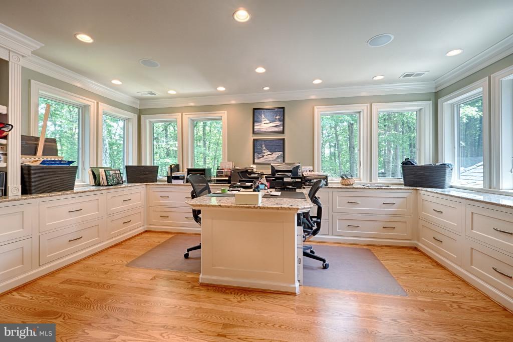 1301 Sawbridge Way Reston, VA 20194 - Photo 20 of 30 a large white kitchen with kitchen island a large window a sink and white cabinets