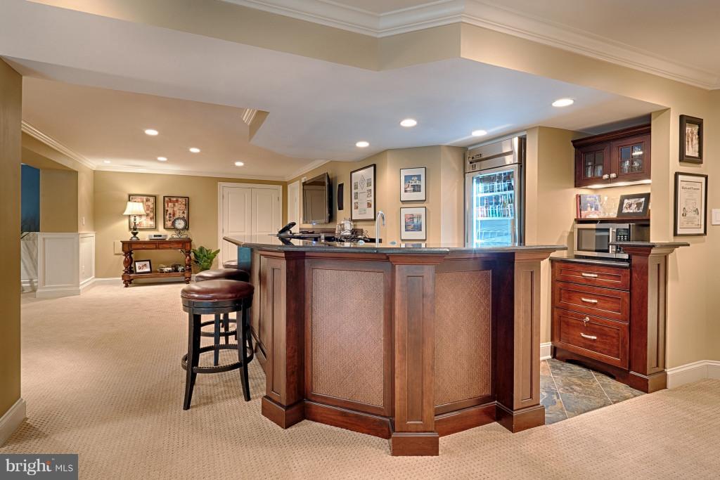 1301 Sawbridge Way Reston, VA 20194 - Photo 24 of 30 a kitchen with stainless steel appliances kitchen island granite countertop a refrigerator and a stove top oven