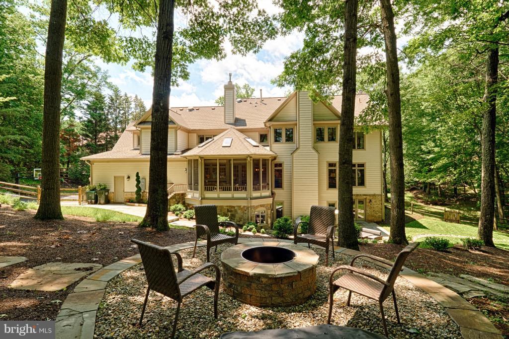 1301 Sawbridge Way Reston, VA 20194 - Photo 28 of 30 a view of a patio with table and chairs and floor to ceiling window