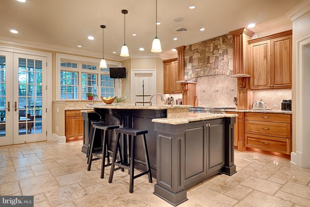 1301 Sawbridge Way Reston, VA 20194 - Photo 9 of 30 a kitchen with kitchen island granite countertop a sink a counter top space appliances and cabinets