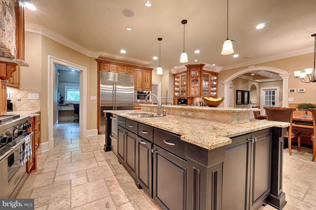 1301 Sawbridge Way Reston, VA 20194 - Photo 10 of 30 a kitchen with center island table and chairs in it