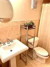 a bathroom with a sink a toilet and mirror