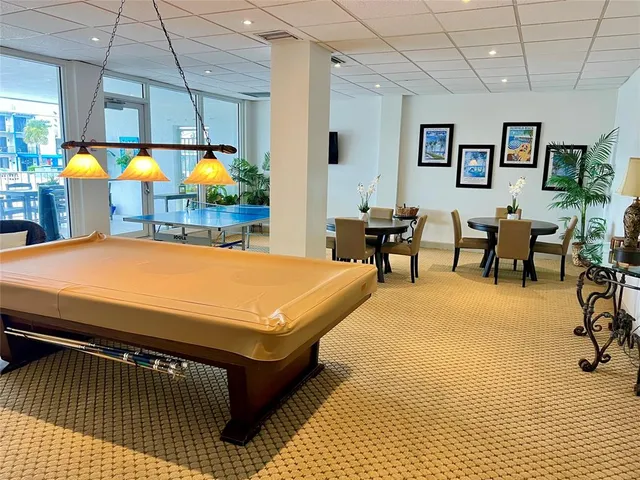 a living room with pool table and a pool table