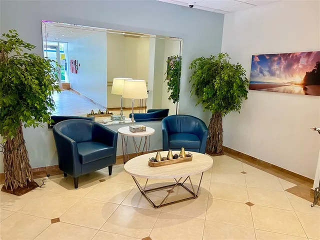 a living room with furniture and a potted plant