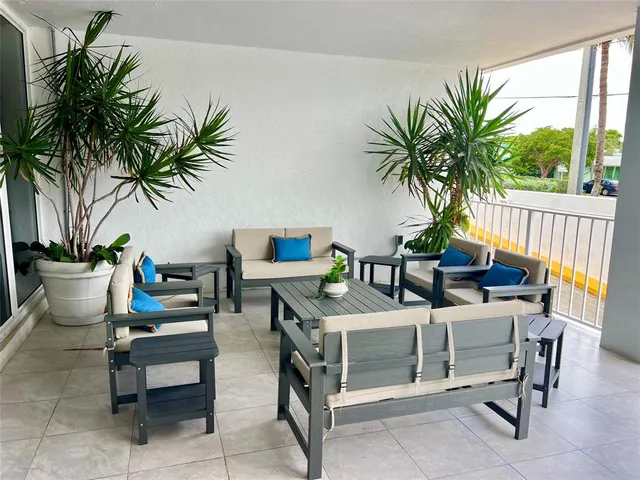 a dining room with furniture and a potted plants
