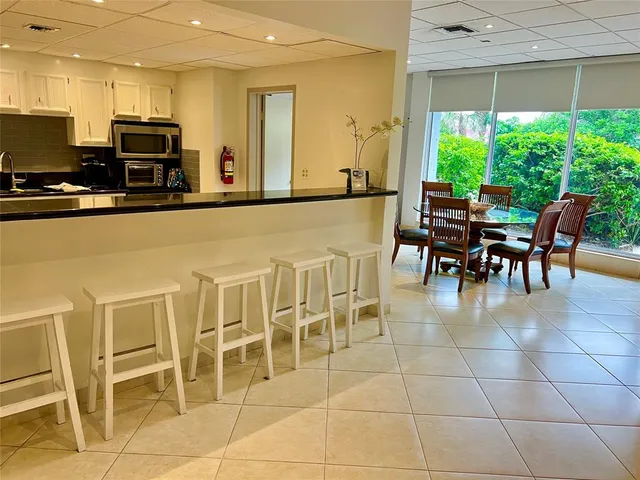 a dining area with furniture a window and kitchen view
