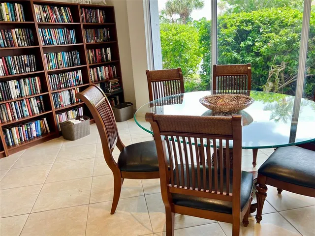 a view of a workspace with furniture and a bookshelf