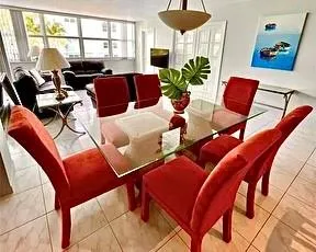 a living room with furniture fireplace and a large window