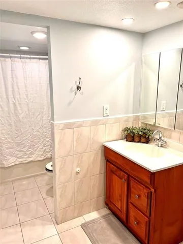 a bathroom with a sink vanity and a mirror