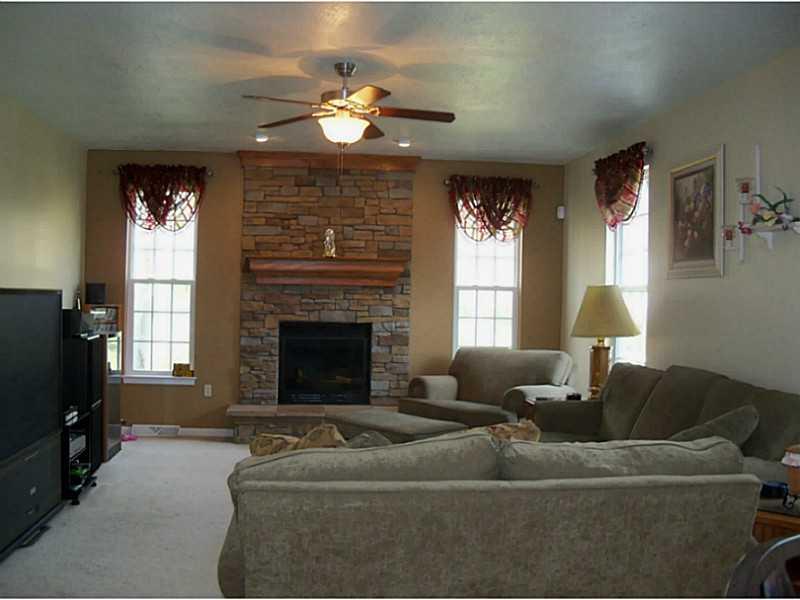 Family Room. Open to Kitchen and Informal Dining with Stone Fireplace