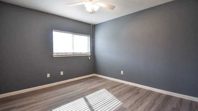wooden floor and window in an empty room