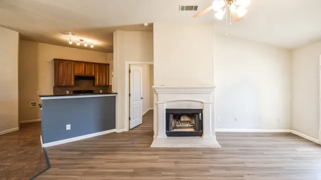 a view of a livingroom with a fireplace and a workspace