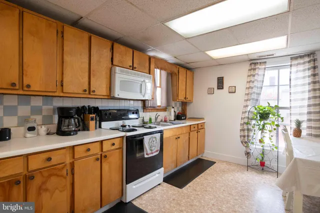 a kitchen with stainless steel appliances granite countertop sink stove and cabinets