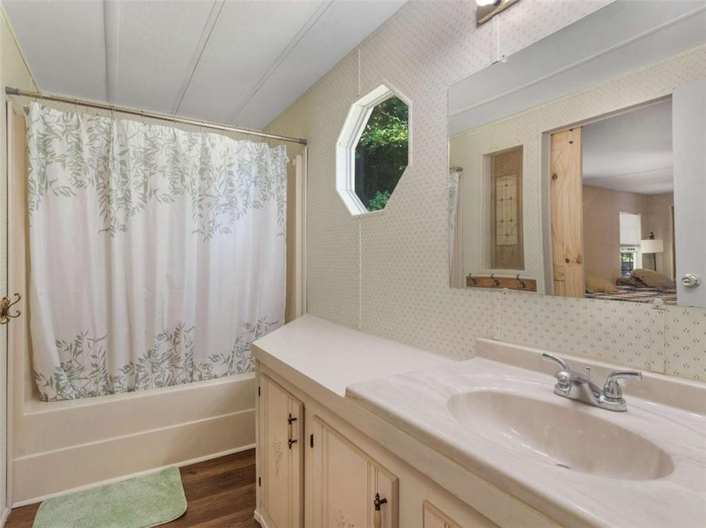 1775 Long Piney Road Mansfield, GA 30055 - Photo 12 of 26 a bathroom with a sink and a mirror