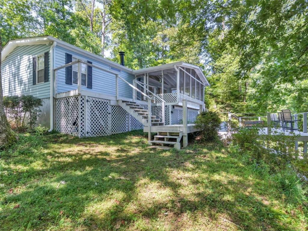 1775 Long Piney Road Mansfield, GA 30055 - Photo 3 of 26 a backyard of a house with large trees and brick walls