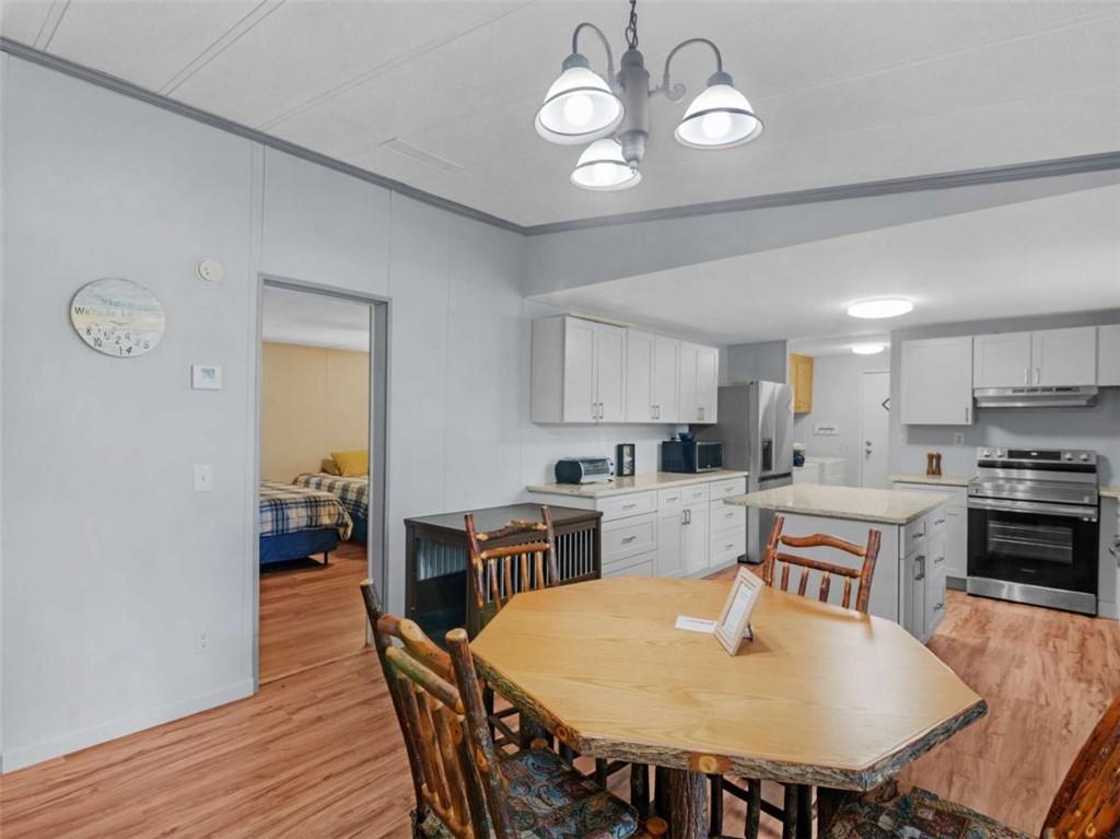 1775 Long Piney Road Mansfield, GA 30055 - Photo 5 of 26 a view of a dining room with furniture a kitchen and chandelier