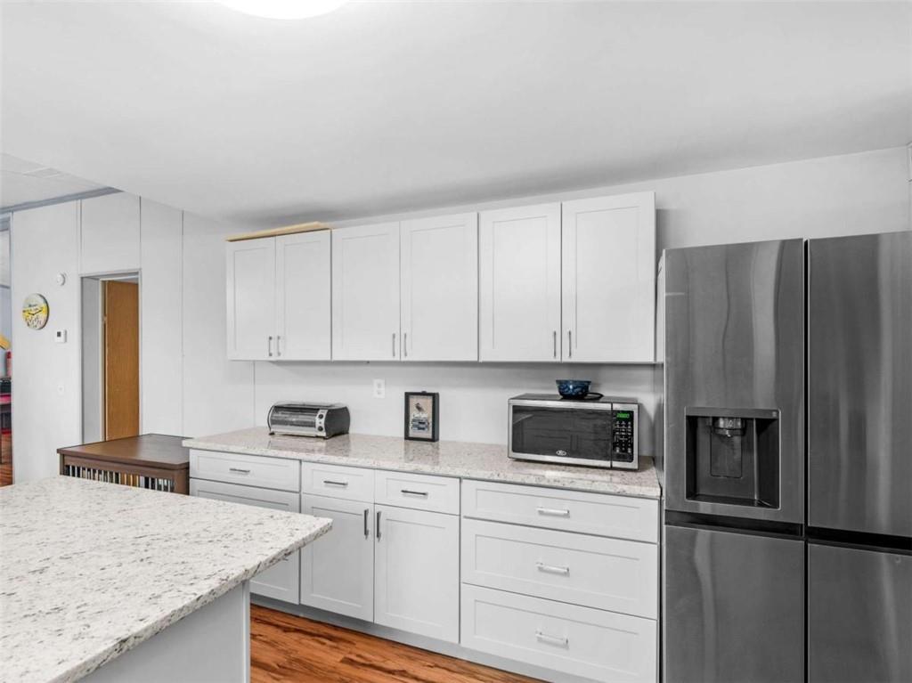 1775 Long Piney Road Mansfield, GA 30055 - Photo 7 of 26 a kitchen with granite countertop a refrigerator sink and stove