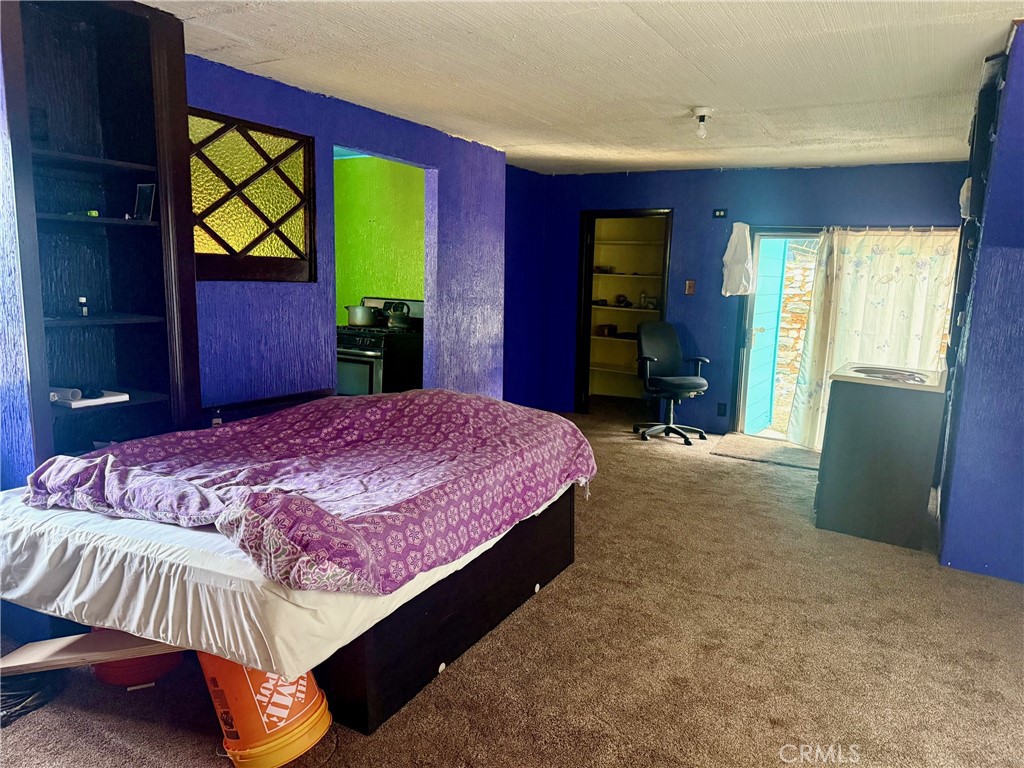 744 Woodland Road Crestline, CA 92325 - Photo 5 of 26 a bedroom with a bed and a large window