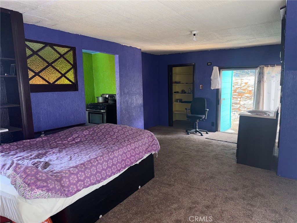 744 Woodland Road Crestline, CA 92325 - Photo 6 of 26 a bedroom with a bed and a window