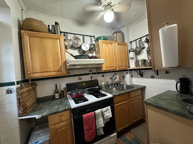 a kitchen with stainless steel appliances granite countertop a sink stove and cabinets