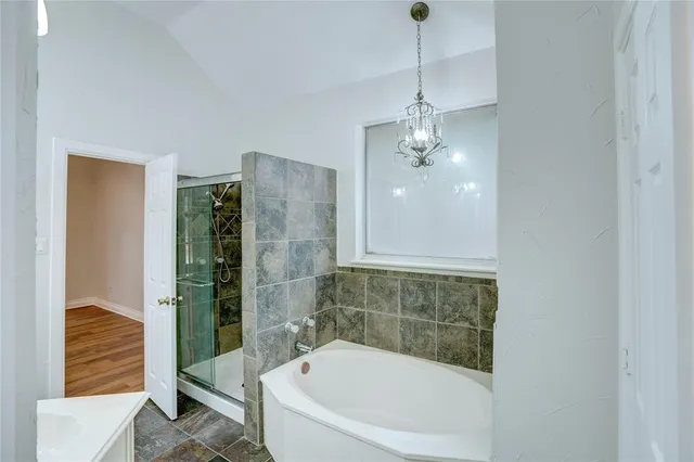 a bathroom with a bathtub and shower
