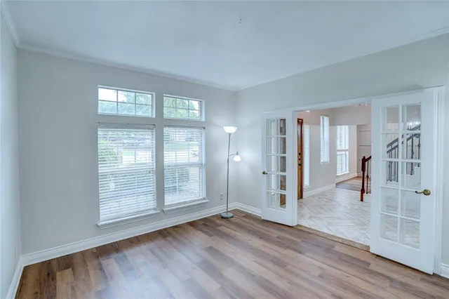 wooden floor in an empty room with a window