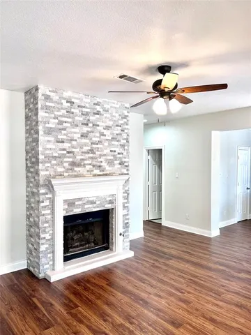 a view of a livingroom with a fireplace and wooden floor