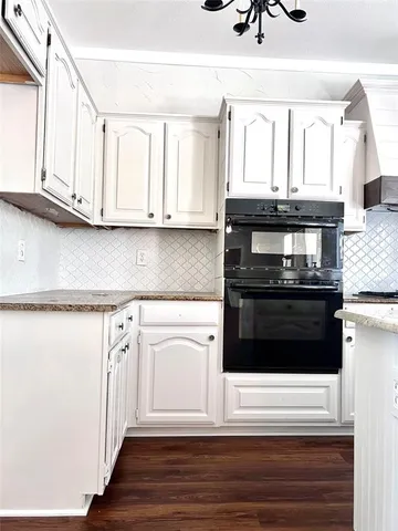 a kitchen with stainless steel appliances white cabinets and a refrigerator